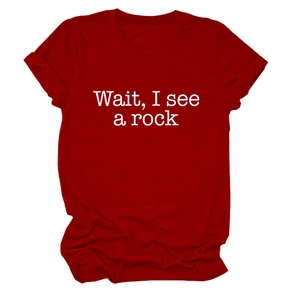 Detail of red crew neck cotton T-shirt featuring 'Wait, I see a rock' artistic white print