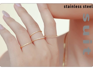 Detail of four stackable 18k gold plated stainless steel rings with micro-pave cubic zirconia