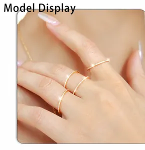 Close-up of four minimalist 18k gold plated stainless steel rings with micro pavé zircons
