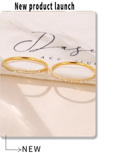 Macro shot of two 18k gold plated stainless steel rings with micro-pave crystals