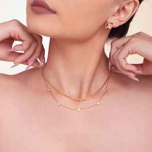 Double-layered 18k gold plated necklace with star pendants and snake chain on model