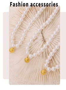 Macro detail of Baroque pearl necklace with a polished gold bead pendant on a coral base