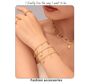 Detail of 18K gold-plated layered necklaces and bracelets with heart and horn pendants