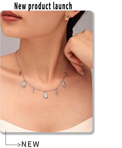 Detail view of 18K gold plated necklace with heart and crescent charms on a model
