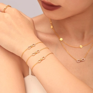 Gold double-layered necklace and bracelet set with infinity zircon pendant