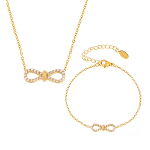 Golden stainless steel jewelry set featuring infinity charms with white cubic zirconia