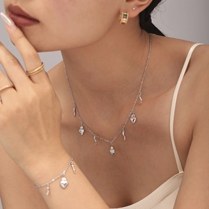 Silver stainless steel jewelry set featuring heart and horn pendants for a boho look