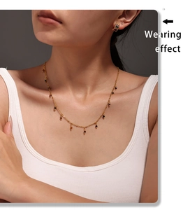 Close-up of double layered 18K gold-plated necklace with delicate dark natural stone beads