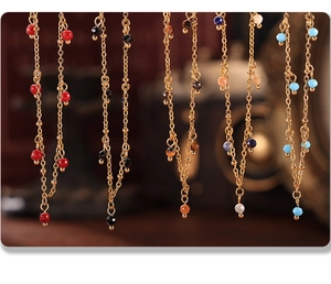 Detail view of 18K gold plated chains with multi-color faceted natural stone beads