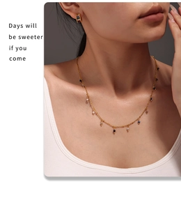 Detail of 18K gold-plated necklace with colorful beads on a model for casual look