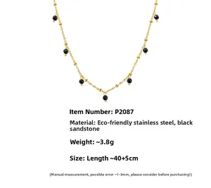 Detail view of double layer gold stainless steel necklace with black goldstone beads