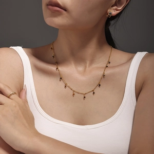 Double-layered 18K gold plated necklace with small natural stone beads worn by a model