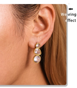 Wearing effect of gold drop earrings with three-stone vertical zircon inlay design
