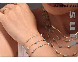 Macro shot of stainless steel layered chain necklace and turquoise bead bracelet set