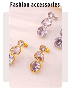 Detailed view of long vertical triple zircon earrings in 18K gold and silver plating