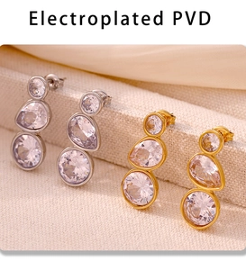 Close-up of PVD electroplated gold and silver drop earrings with triple cubic zirconia stones
