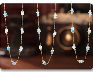 Detail of gold chain necklace with amazonite beads and vintage aesthetic background