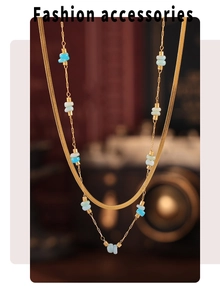 Close-up of gold double-layer necklace with flat snake chain and blue amazonite beads