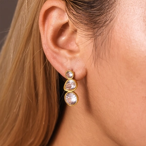 Three-stone gold drop earrings with gradient round zircon stones on ear model
