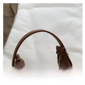 Detail of comfortable brown suede handle with seamless stitching and metal zipper