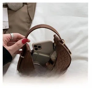 Interior view showing the storage capacity of a brown faux crocodile crescent bag