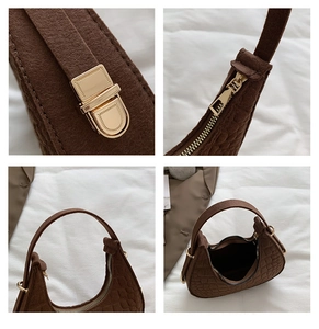 Detailed close-up of dark brown felt handbag hardware, crocodile texture, and zipper