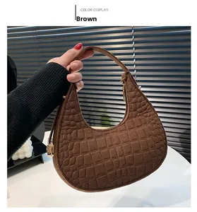 Detail showing brown crocodile-embossed felt hobo bag with vintage gold hardware