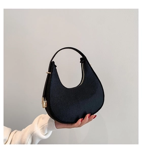 Detail view of black crescent hobo bag with wool texture and golden zipper accents