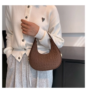 Brown crocodile pattern felt shoulder bag shown on model for a trendy daily casual look