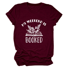 Detail of burgundy T-shirt showing printed book and My Weekend Is Booked graphic