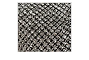 Close-up of sparkling silver rhinestones densely set on high-quality black mesh fabric
