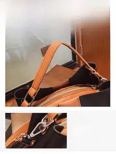 Detail des ergonomischen braunen Griffs und der silbernen Hardware an der Beuteltasche