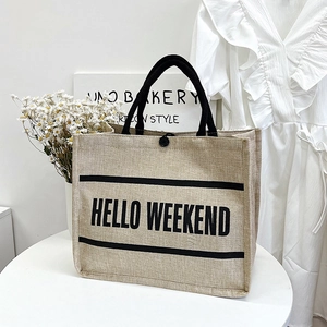 Linen tote bag with Hello Weekend print and black handles for shopping and beach use