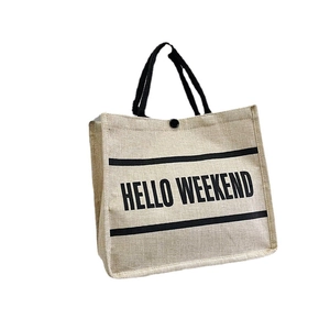 Minimalist linen tote bag with Hello Weekend slogan and black handles for daily shopping