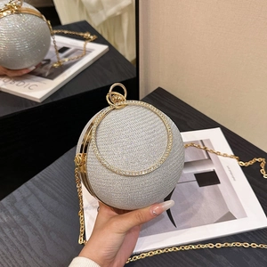 Détail du sac de soirée sphérique en strass argentés avec poignée anneau doré et chaîne