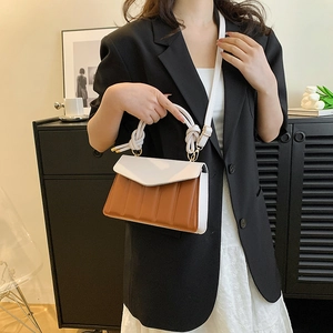 Two-tone caramel and white leather crossbody bag with vertical texture and knot handle