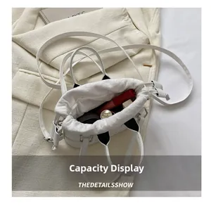 Internal capacity of the white shell handbag showing space for lipstick and makeup items