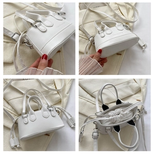 Detailed view of white mini shell bag featuring drawstrings and adjustable strap