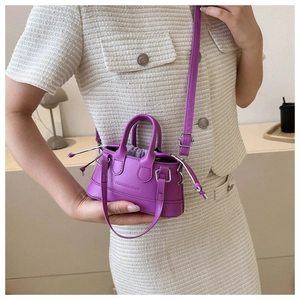 Detail of purple faux leather mini bag with drawstring lining and embossed logo