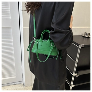 Mini green shell bag with fashion print and drawstring detail worn by a model