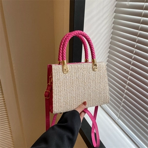 Minimalist straw tote bag with pink woven handles and adjustable shoulder strap for summer