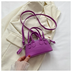 Detail view of mini purple seashell bag with logo embossing and velvet drawstring lining