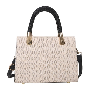 Women's woven tote bag in cream straw with black braided handles and gold-tone hardware