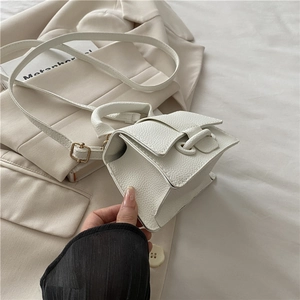 Detail of white lychee texture leather mini square bag with strap and metal buckle