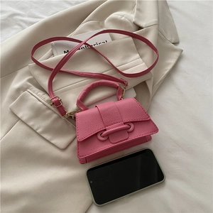Detailed view of pink lychee leather mini bag with chain strap and top handle