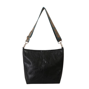 Large black faux leather bucket bag with a colorful retro jacquard wide shoulder strap