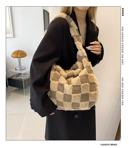 Detail shot of khaki and cream plush checkered tote bag with soft faux fur texture