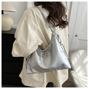 Silver metallic crescent shoulder bag with star logo and chain strap shown from back view