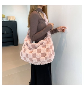 Stylish large capacity plush checkerboard tote bag shown worn by a model in a minimal interior