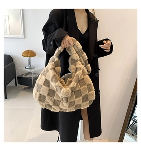 Close-up of stylish large plush checkerboard tote bag for women in khaki and cream colors